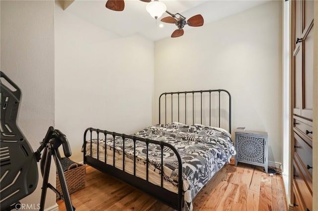 bedroom featuring hardwood / wood-style flooring and ceiling fan