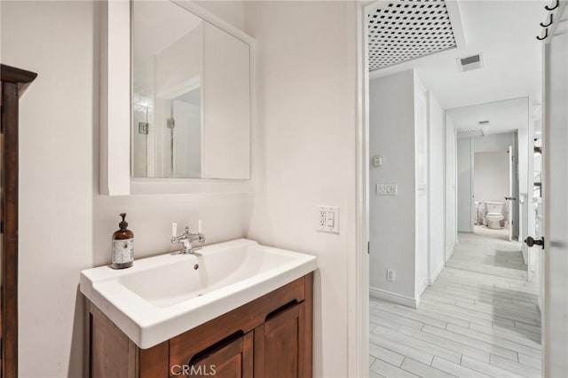 bathroom with vanity and wood-type flooring