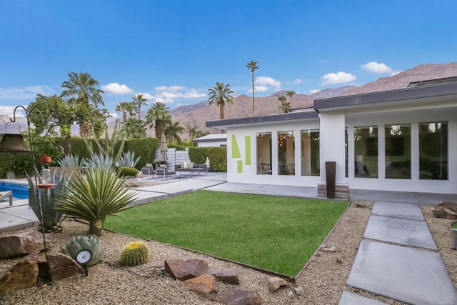 exterior space featuring a mountain view and a patio