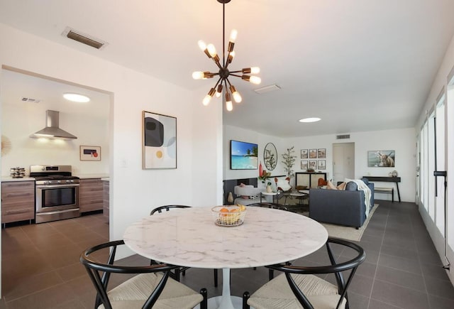 dining room with dark tile patterned flooring and an inviting chandelier