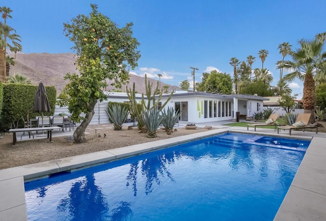 view of pool with a patio area and a mountain view