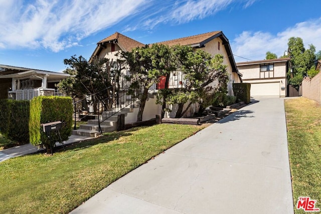 view of front facade with a garage and a front lawn