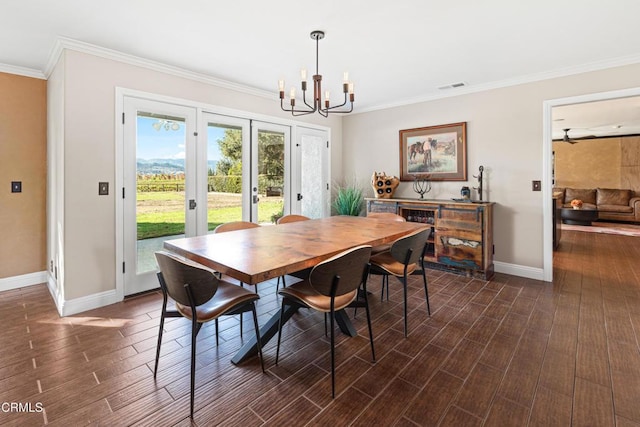 dining area featuring crown molding, an inviting chandelier, and french doors