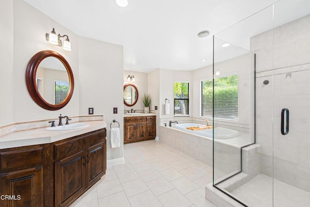 bathroom featuring tile patterned flooring, vanity, and separate shower and tub