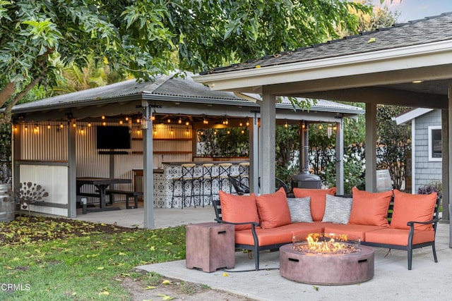 view of patio with an outdoor living space with a fire pit, a gazebo, and an outdoor bar