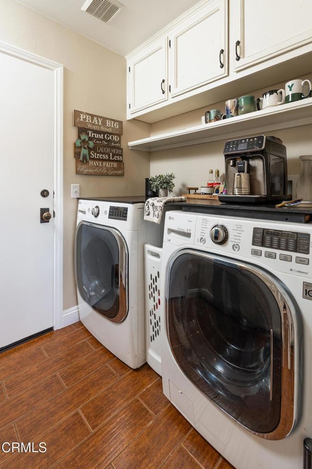 laundry area with cabinets and separate washer and dryer