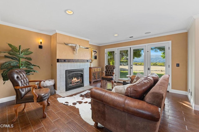 living room with crown molding, a fireplace, and french doors