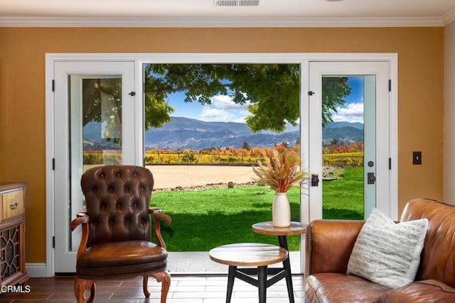 doorway featuring a mountain view and crown molding