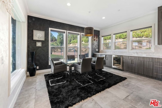 dining area with crown molding and beverage cooler