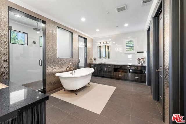 bathroom with tile patterned flooring, vanity, separate shower and tub, and ornamental molding