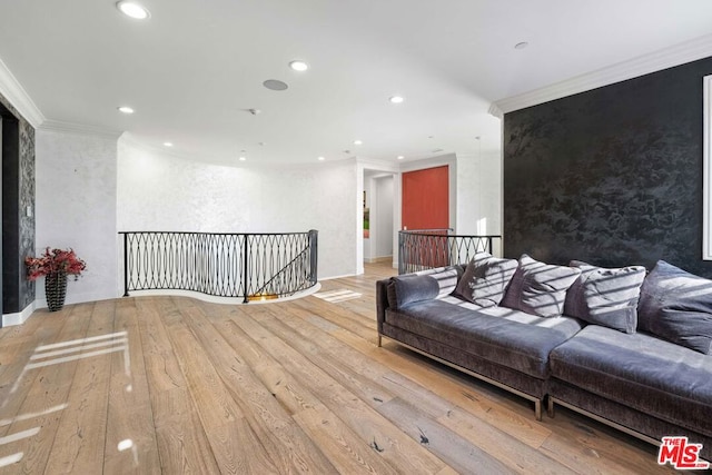 living room featuring ornamental molding and light wood-type flooring