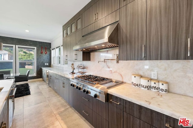 kitchen featuring decorative backsplash, stainless steel appliances, crown molding, exhaust hood, and light tile patterned floors