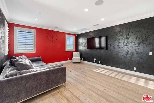 living room with light hardwood / wood-style floors, plenty of natural light, and crown molding