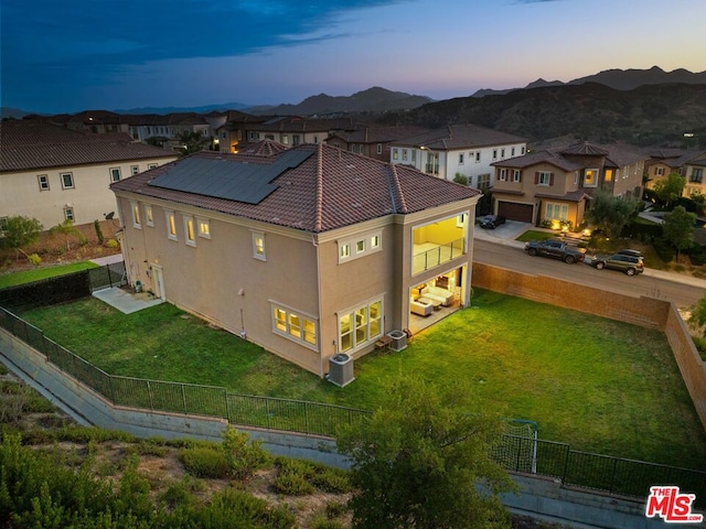 aerial view at dusk featuring a mountain view