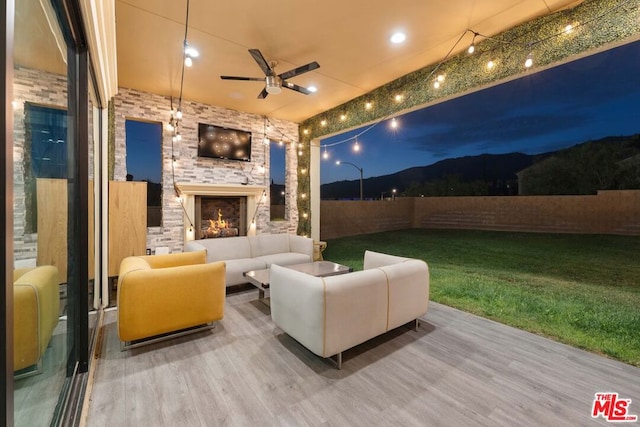 view of patio / terrace featuring an outdoor living space with a fireplace