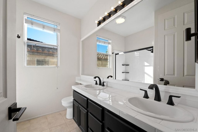 bathroom featuring tile patterned floors, toilet, walk in shower, and vanity