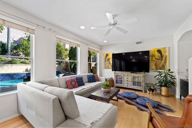 living room with light hardwood / wood-style floors and ceiling fan