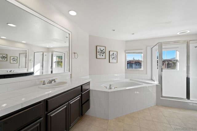 bathroom featuring vanity, tile patterned floors, and separate shower and tub