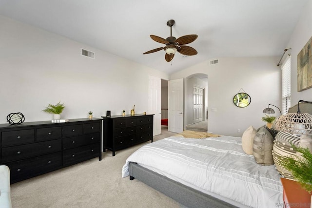 bedroom featuring ceiling fan, lofted ceiling, and light carpet