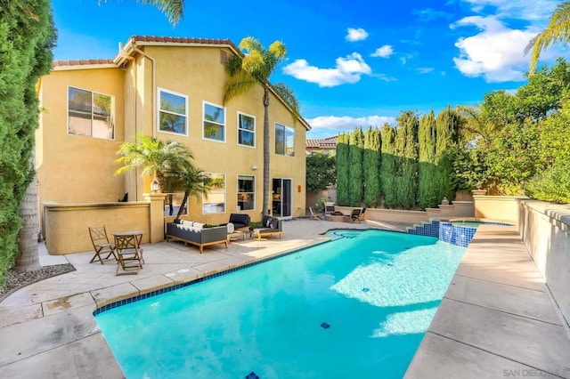 view of pool with an in ground hot tub, a patio, and an outdoor hangout area