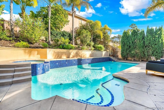 view of swimming pool with an in ground hot tub and a patio area