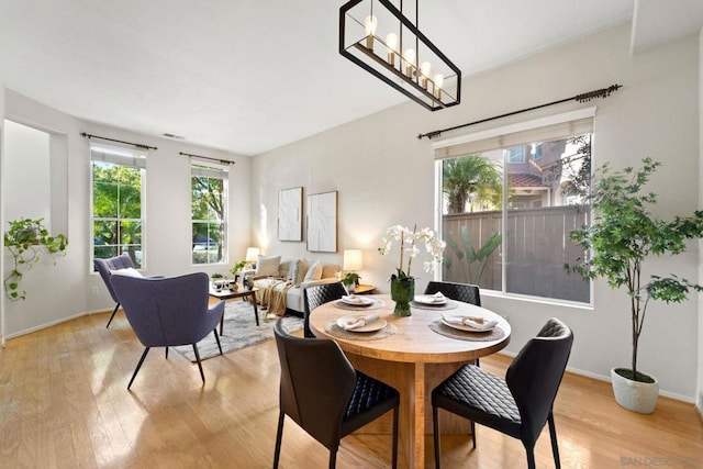 dining space with a wealth of natural light and light hardwood / wood-style flooring