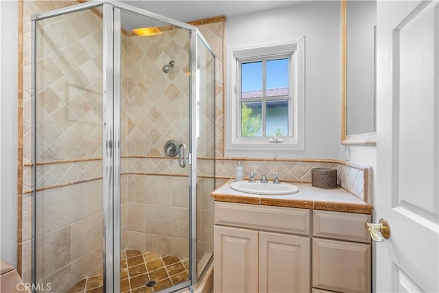 bathroom featuring vanity and a shower with shower door