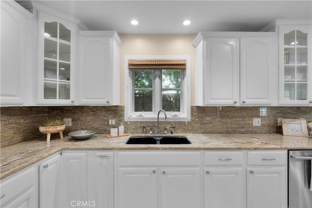 kitchen with backsplash, sink, and white cabinets