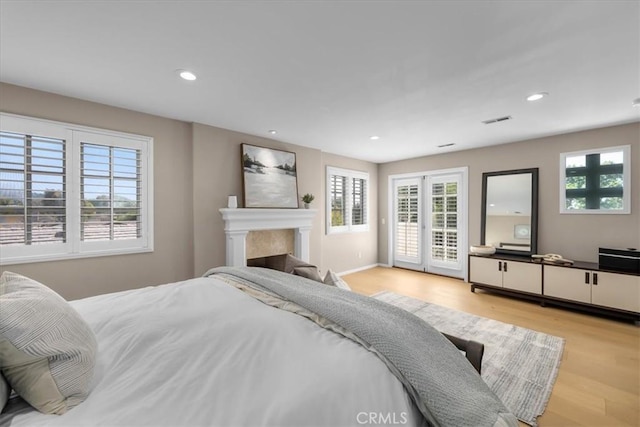 bedroom featuring access to outside and light hardwood / wood-style floors