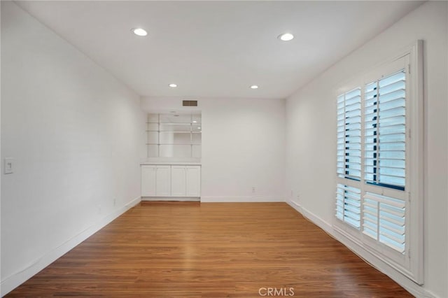 unfurnished room featuring hardwood / wood-style flooring