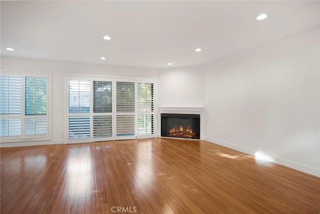 unfurnished living room with hardwood / wood-style floors