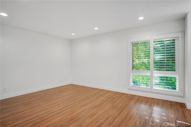 spare room with wood-type flooring