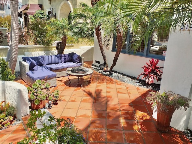 view of patio featuring an outdoor living space with a fire pit