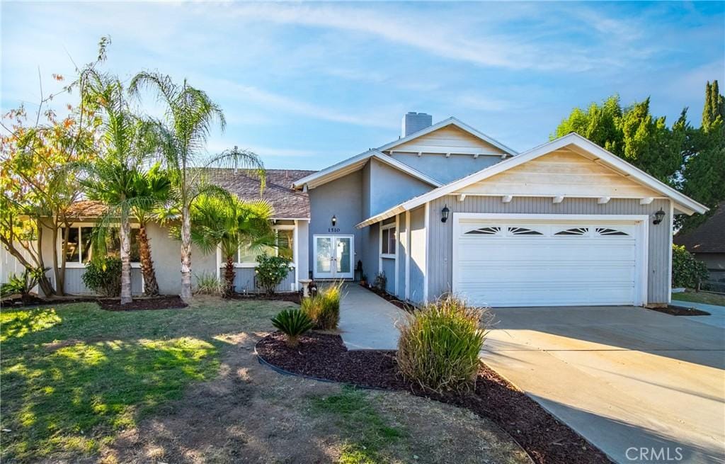 view of front of home featuring a garage and a front lawn