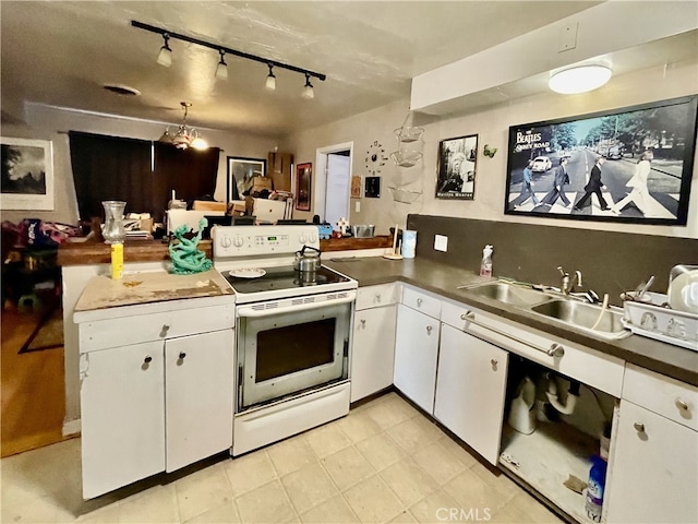 kitchen featuring white cabinets, electric range, and sink