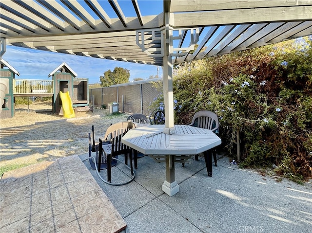 view of patio featuring a playground and a pergola