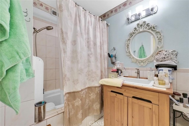 bathroom featuring shower / tub combo, vanity, and tile walls