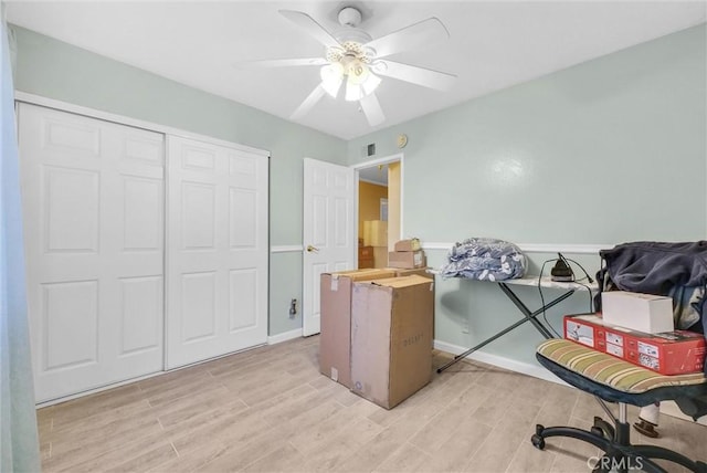 interior space with ceiling fan, a closet, and light hardwood / wood-style flooring