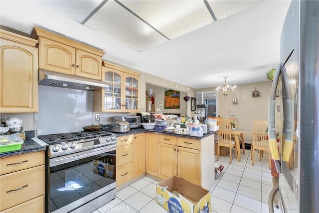 kitchen featuring kitchen peninsula, appliances with stainless steel finishes, a chandelier, and light brown cabinetry