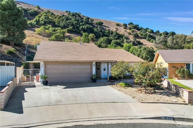 single story home featuring a mountain view and a garage