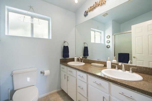 bathroom featuring toilet, tile patterned floors, an enclosed shower, and vanity