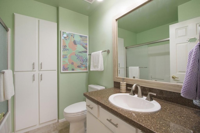 bathroom with toilet, tile patterned floors, an enclosed shower, and vanity