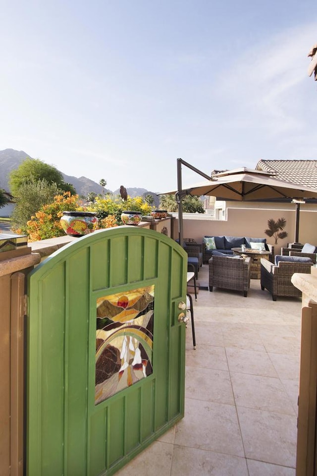 view of patio featuring a mountain view and an outdoor living space