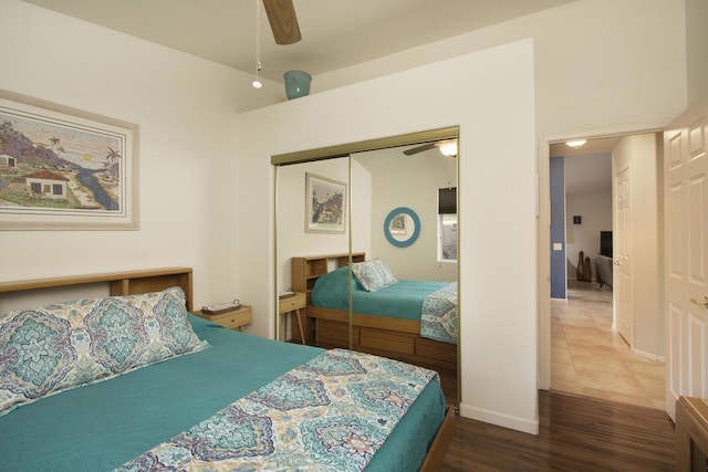 bedroom featuring ceiling fan, a closet, and wood-type flooring