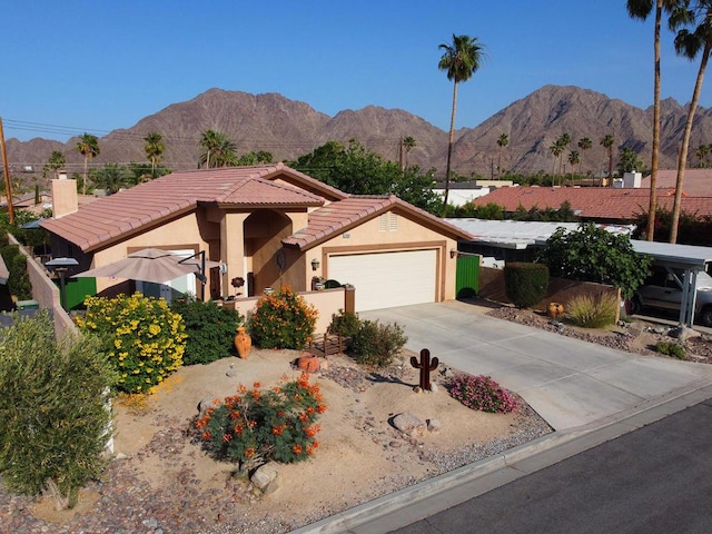 view of front of home with a mountain view and a garage