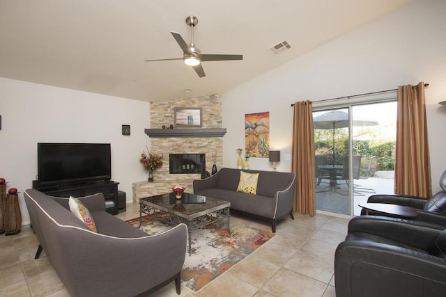 tiled living room with vaulted ceiling, ceiling fan, and a fireplace