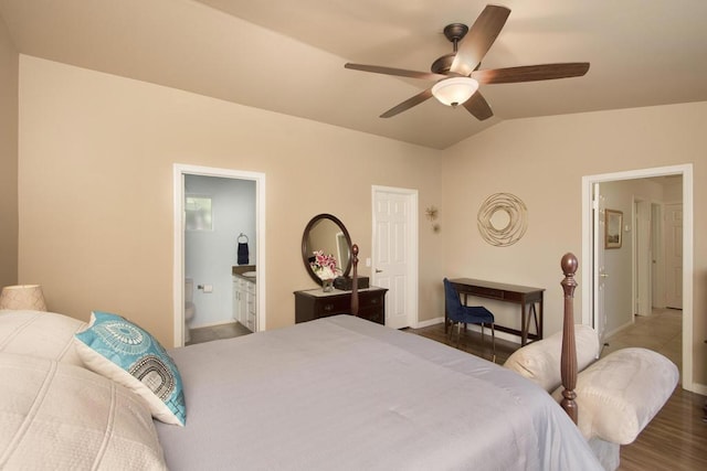 bedroom featuring ceiling fan, lofted ceiling, wood-type flooring, and ensuite bath