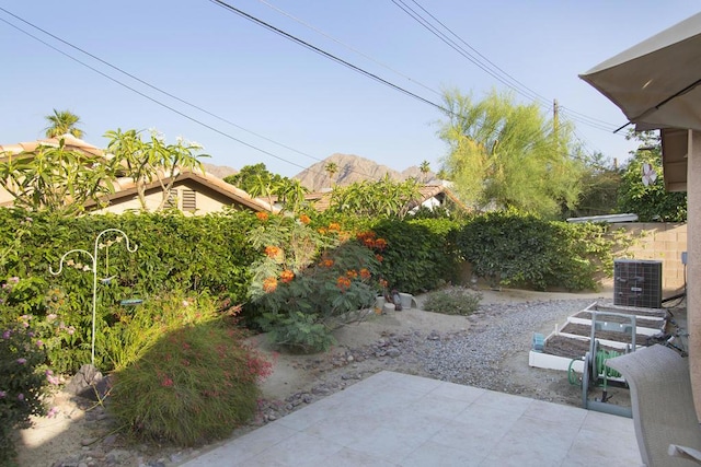 view of patio / terrace featuring central AC and a mountain view