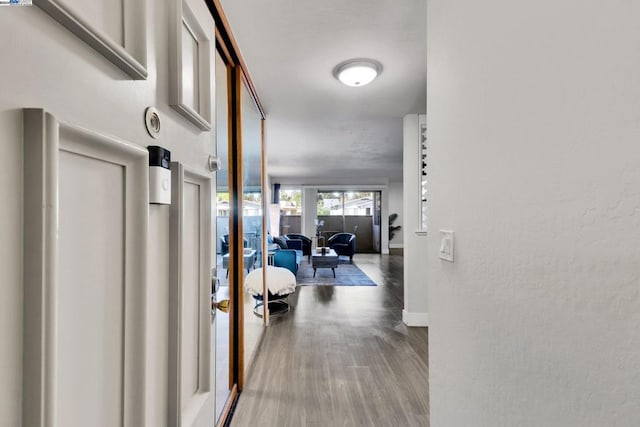 corridor with wood-type flooring