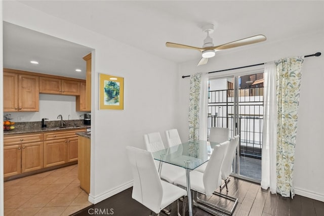 dining area featuring ceiling fan, light hardwood / wood-style floors, and sink